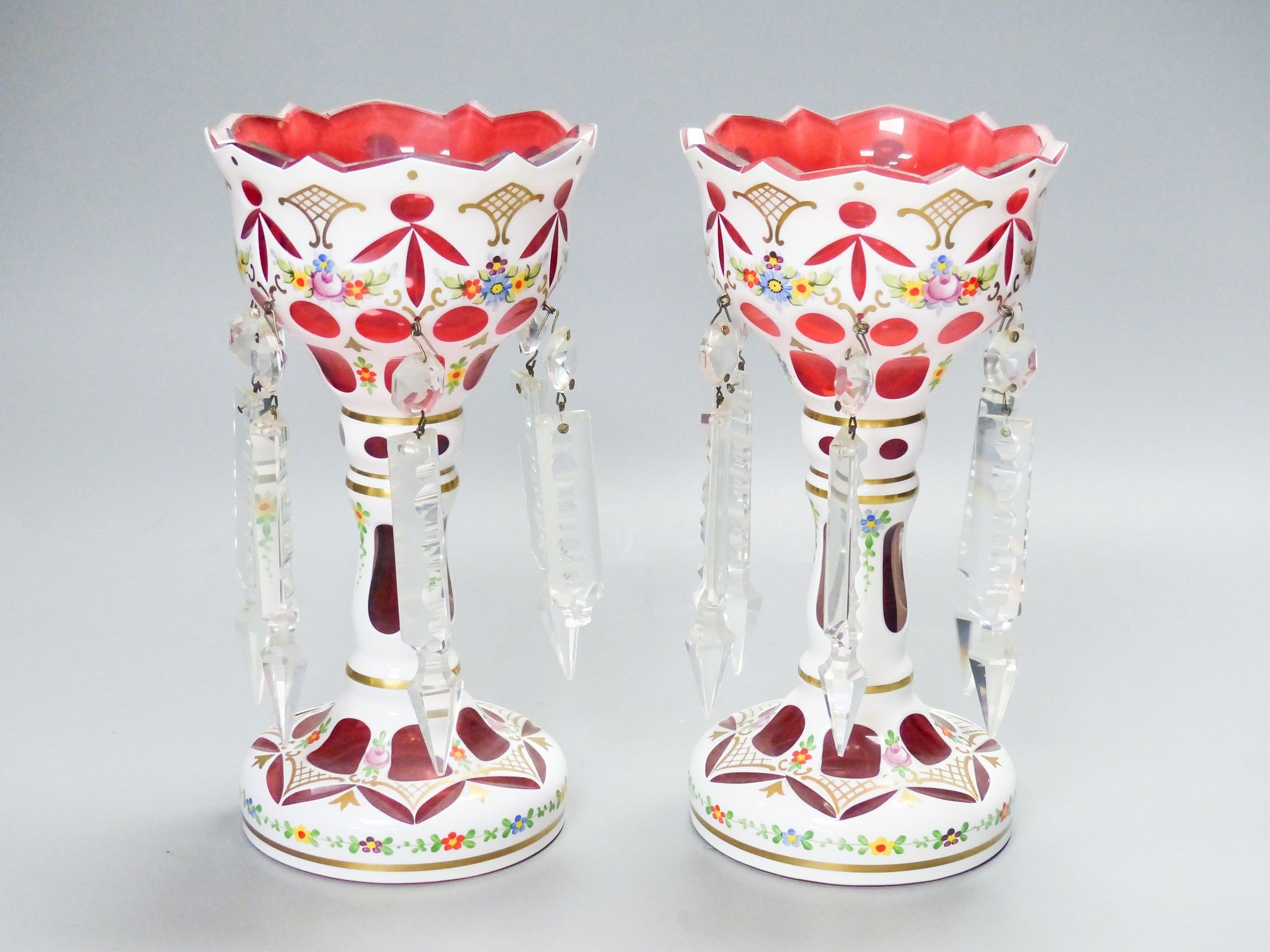 A pair of Bohemian style white and ruby overlaid glass table lustres, 20th century, 20.5 cm high